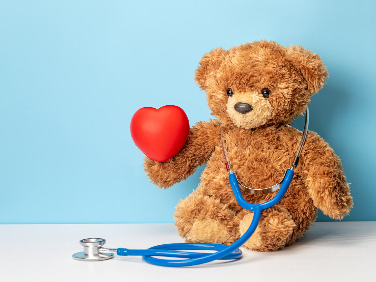 Pediatric care concept with stethoscope around teddy bear neck